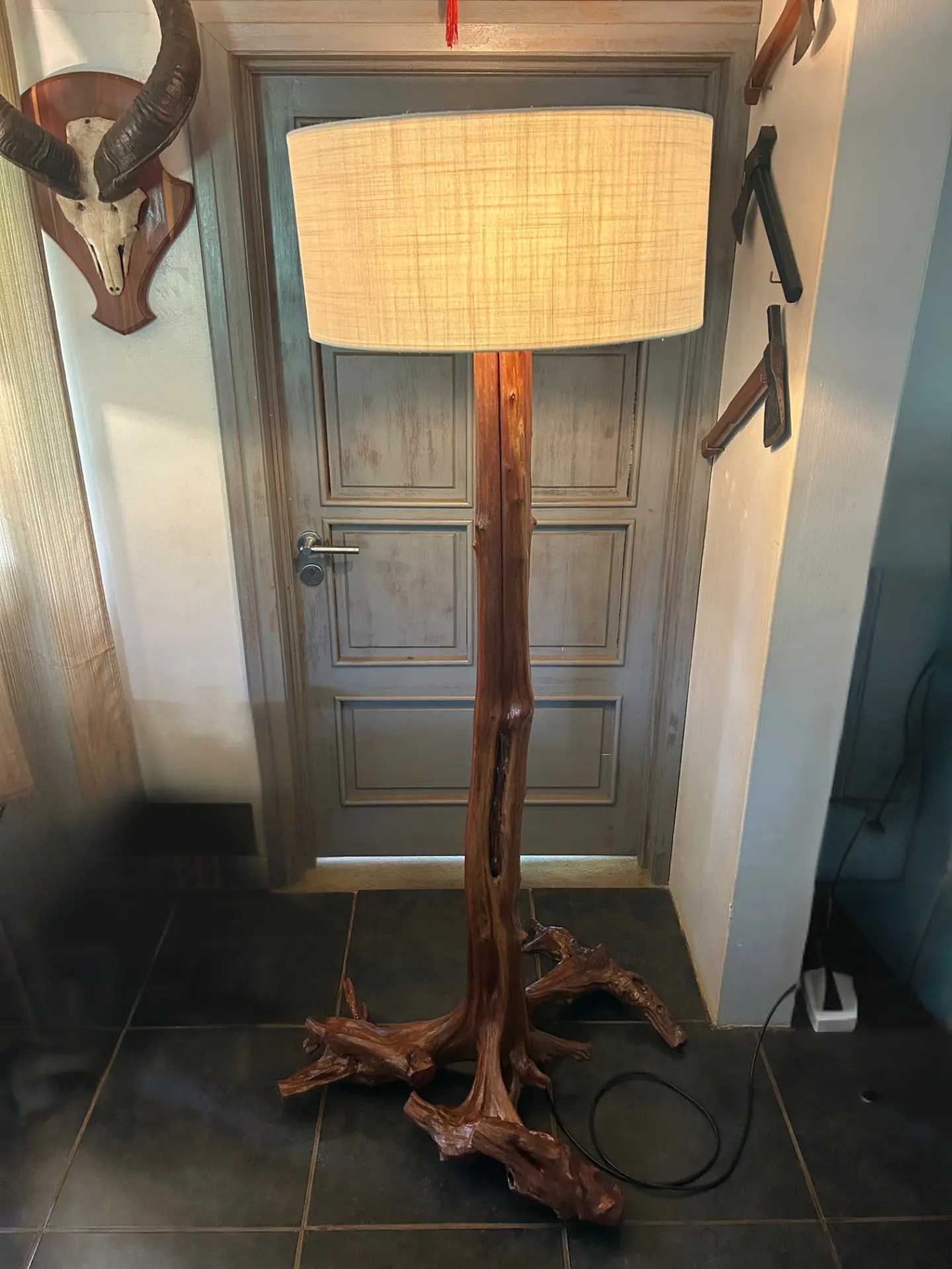 Floor lamp with a polished root trunk and linen shade