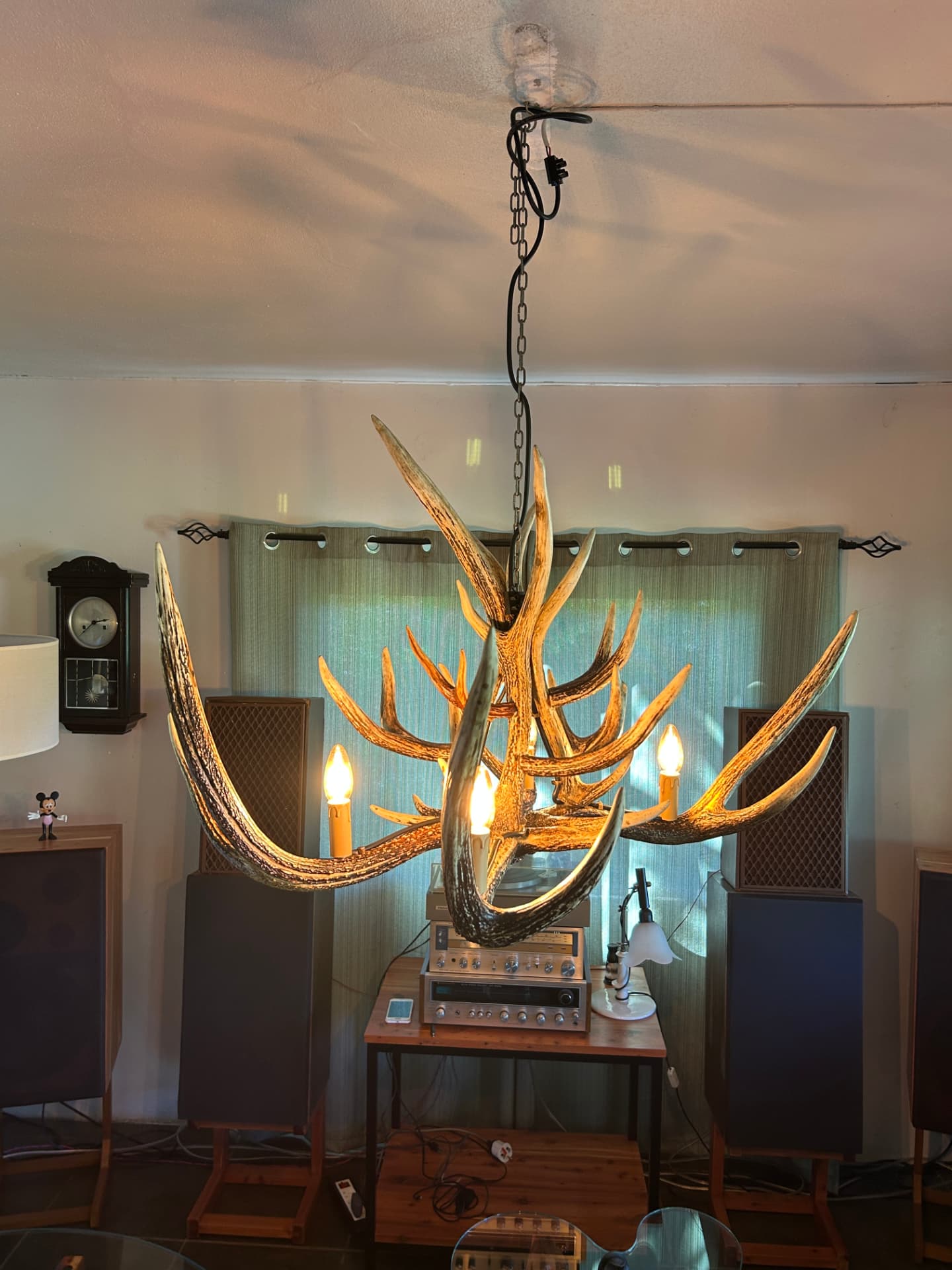 Antler chandelier glowing warmly in a living room